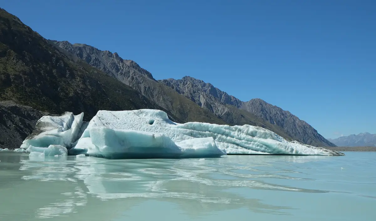 A blue iceberg floating in Tasman Lake